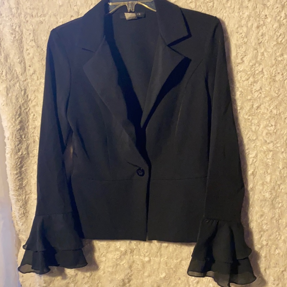 B. Darlin black blazer with ruffle sleeves detail.